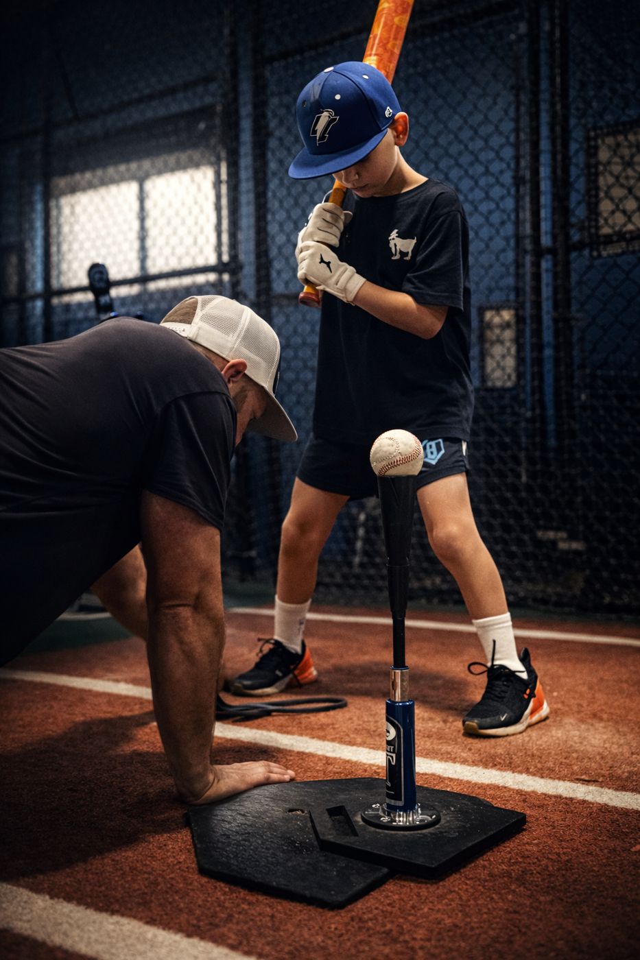Coach Steve working with a young hitter during a training session