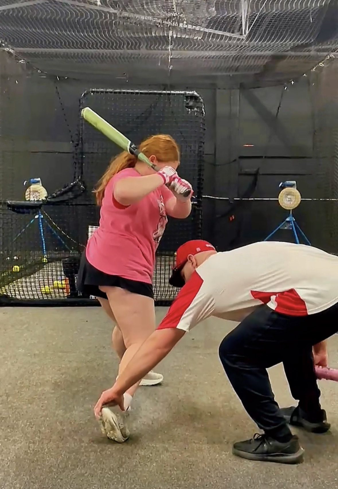 Coach Steve checking a softball hitter's stride foot as she loads during a private session